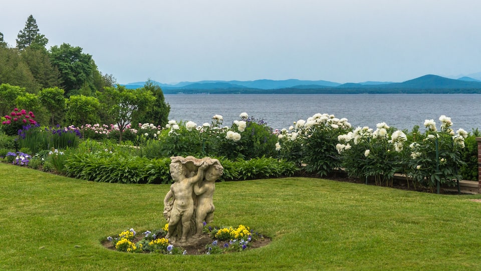 perennial garden with spring flowers blooming offering a view to the lake and mountains