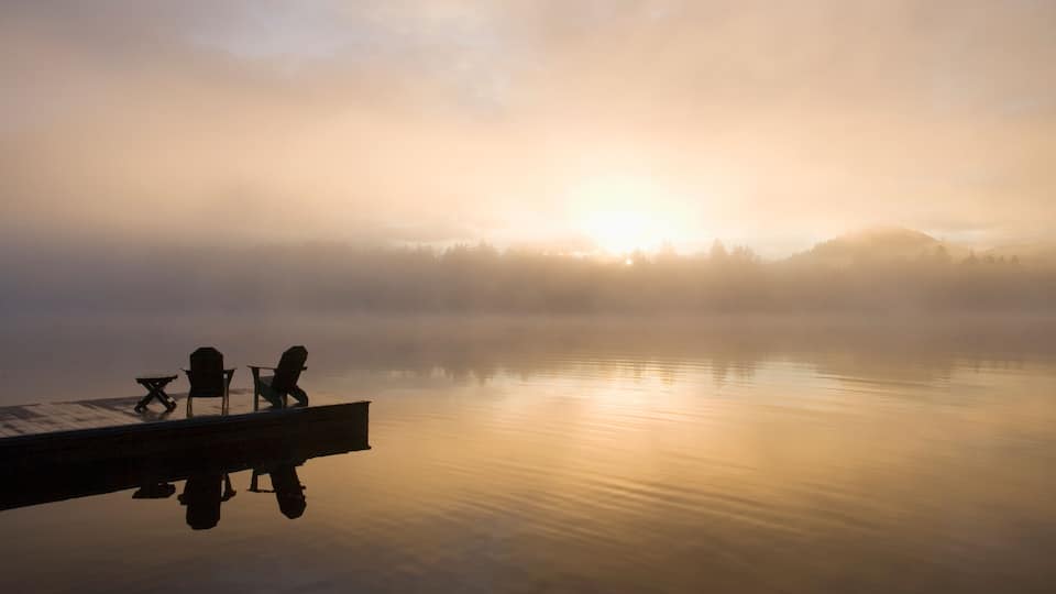 USA, New York State, Adirondack State Park, Morning mist on lake in Adirondack Mountains