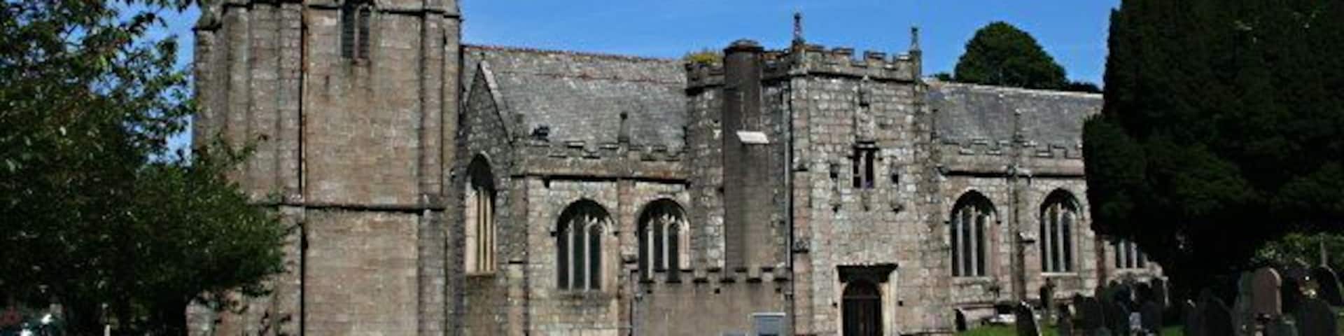 A historic church with a tall tower and arched windows.