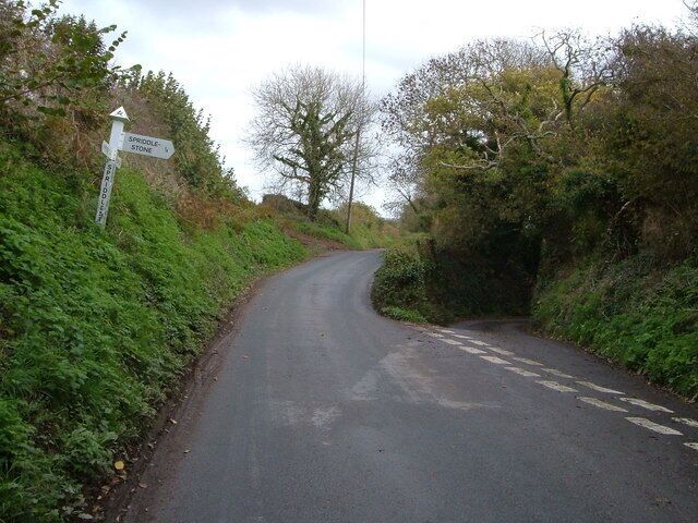 Spriddlestone Cross The small lane to the right plunges down to Spriddlestone; the main lane ahead goes to Brixton.