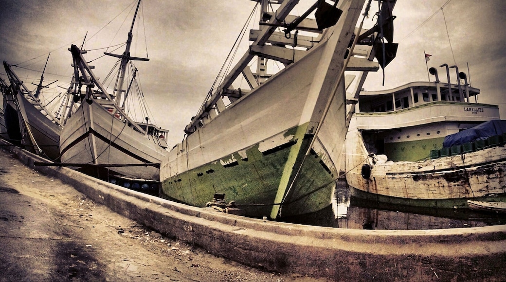 The Phinisi line up at Sunda Kelapa Harbour
Sunda Kelapa is the old port of Jakarta located on the estuarine of Ciliwung River. "Sunda Kalapa" (Sundanese: "Coconut of Sunda") is the original name, and it was the main port of Sunda Kingdom of Pajajaran. The port is situated in Penjaringan sub-district, of North Jakarta, Indonesia. Today the old port only accommodate pinisi, a traditional two masted wooden sailing ship serving inter-island freight service in the archipelago. Although it is now only a minor port, Jakarta had its origins in Sunda Kelapa and it played a significant role in the city's development.
The pinisi or phinisi is a traditional Indonesian two-masted sailing ship. It was mainly built by the Konjo tribe, a sub-ethnic group of Bugis-Makassar mostly residents at the Bulukumba regency of South Sulawesibut was, and still is used widely by the Buginese andMakassarese, mostly for inter-insular transportation, cargo and fishing purposes within Indonesian archipelago.