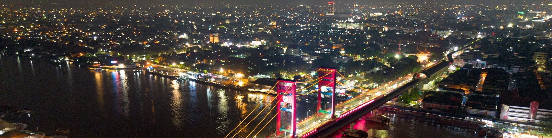 Aerial shot of Ampera Bridge at night, one of the landmarks of Palembang city, South Sumatra, Indonesia