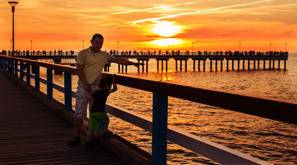pier on the sea. sunset. Palanga. father and son walking along the waterfront