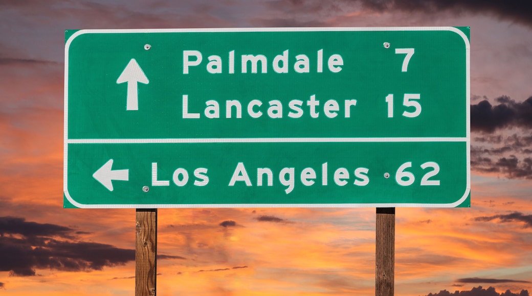 Palmdale, Lancaster and Los Angeles Highway Sign with Sunset Sky