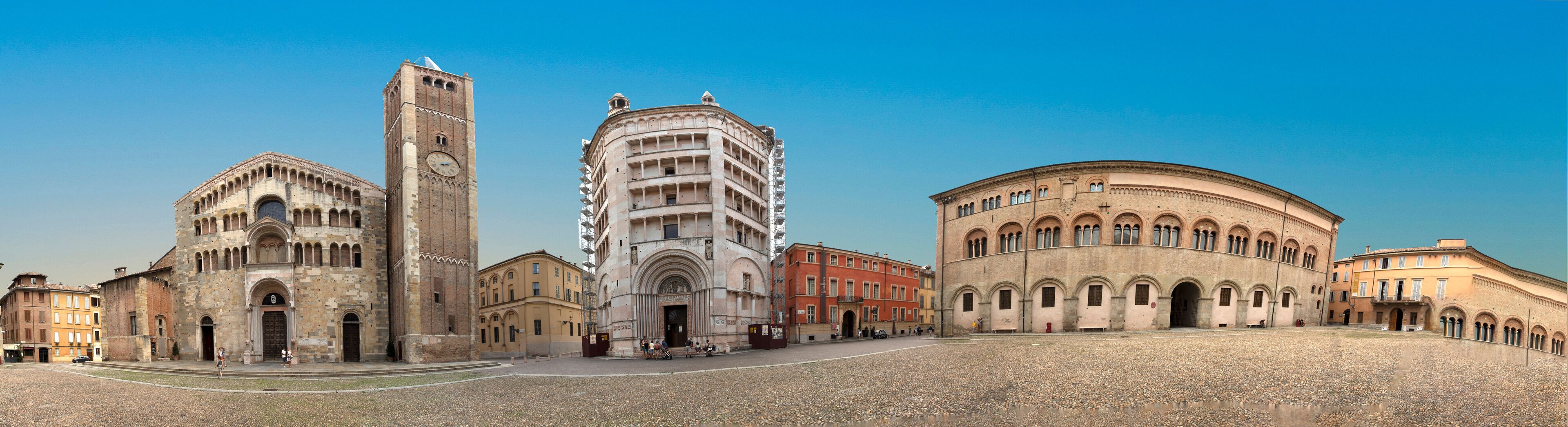 A historic square with a church, a bell tower, and a round building.