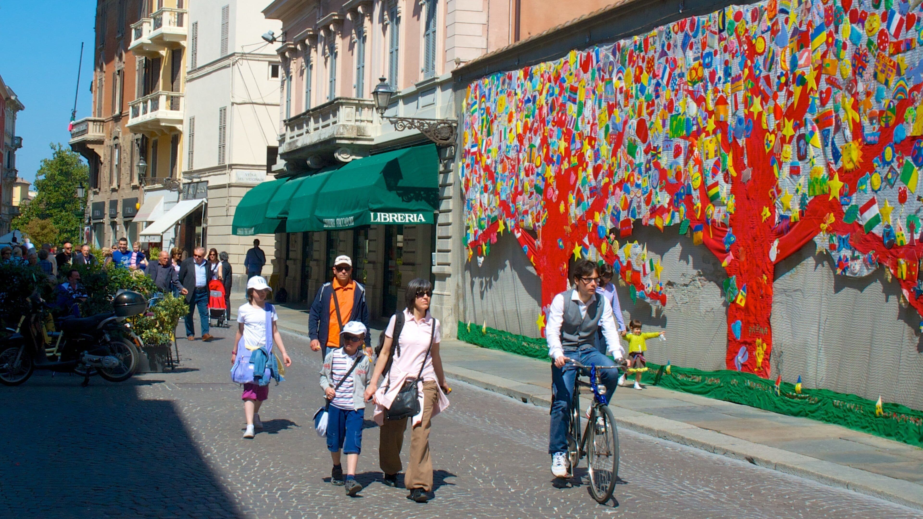 Parma featuring outdoor art and cycling as well as a family