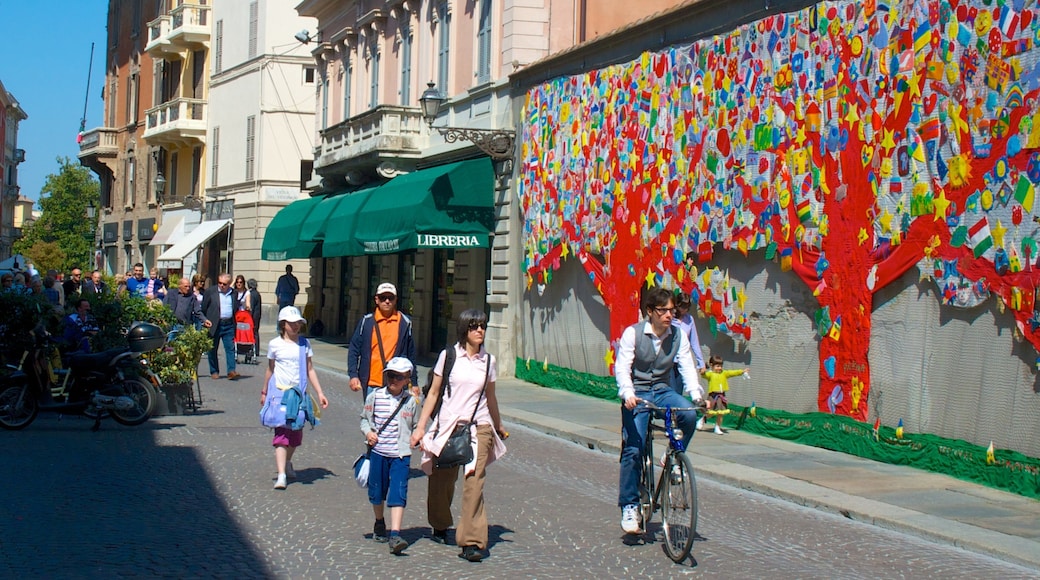Parma featuring outdoor art and cycling as well as a family