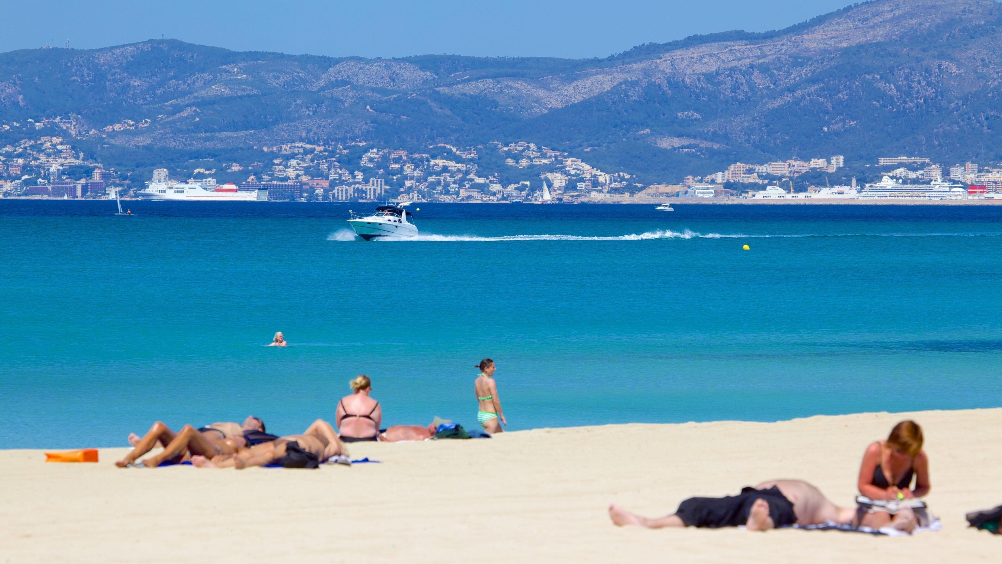 Palma de Mallorca which includes a beach as well as a small group of people