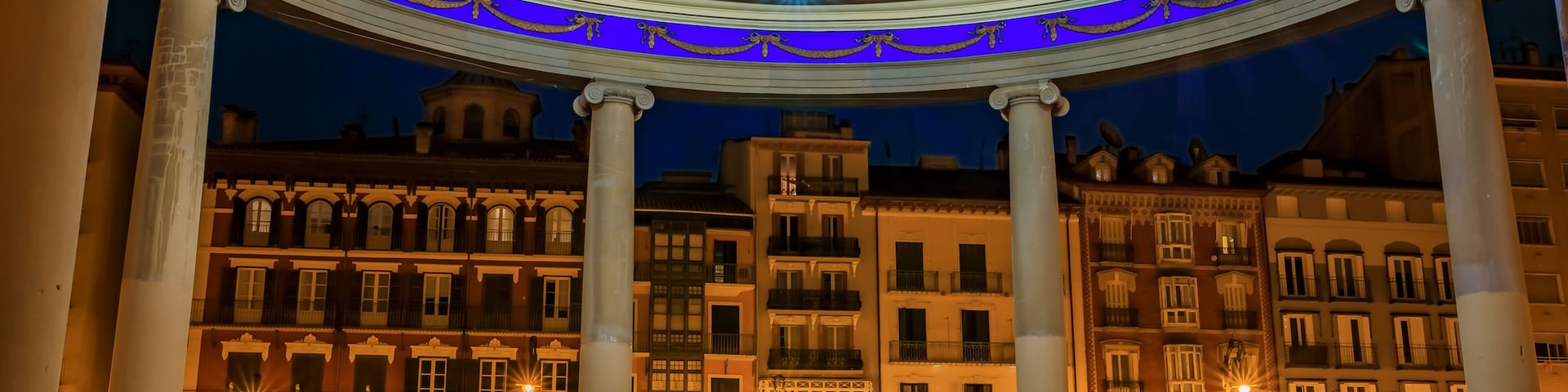 A grand building with a blue-lit dome and classical columns.