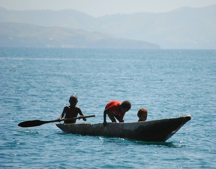 Young children out for a boat ride in the harbour at Port Moresby.