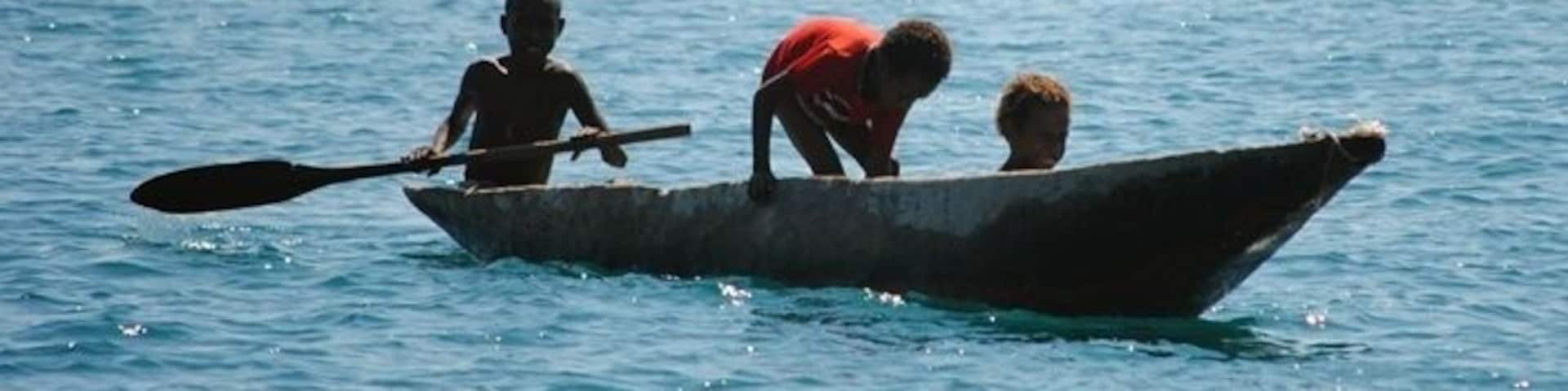 Young children out for a boat ride in the harbour at Port Moresby.