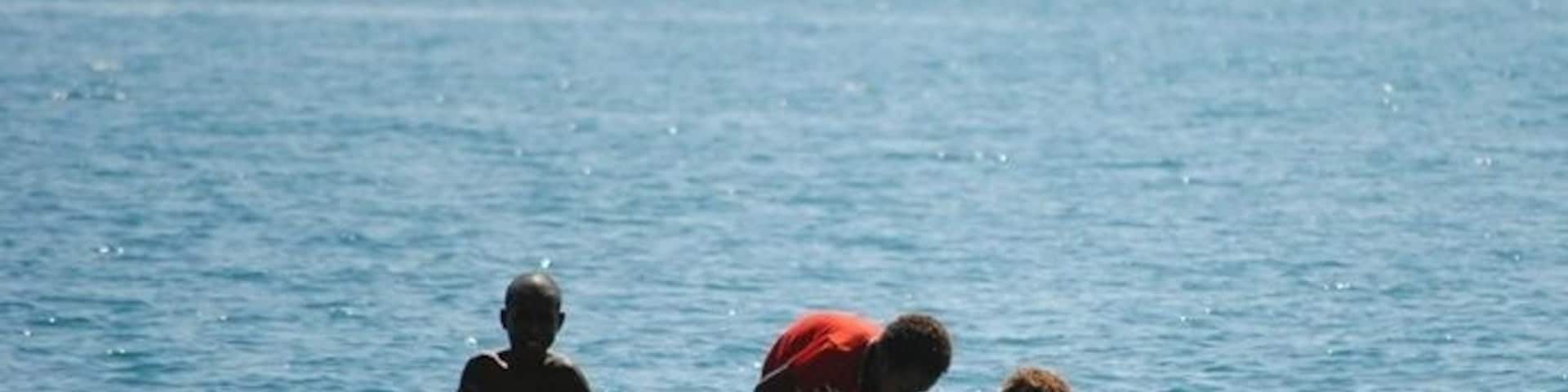Young children out for a boat ride in the harbour at Port Moresby.