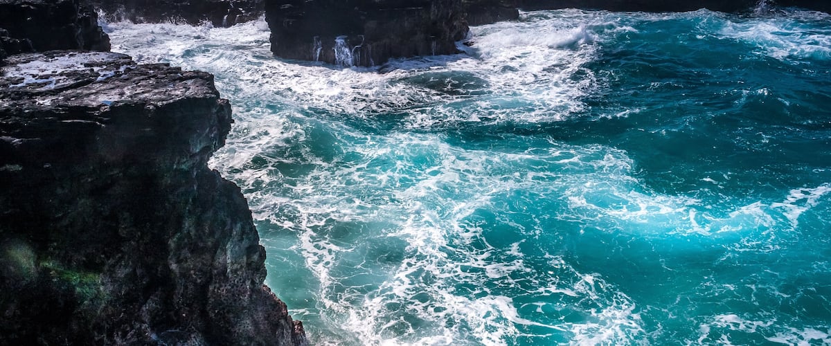 A rocky coastline with waves crashing against the rocks.
