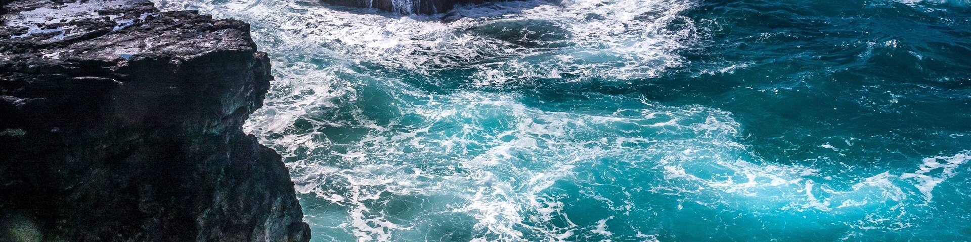 A rocky coastline with waves crashing against the rocks.