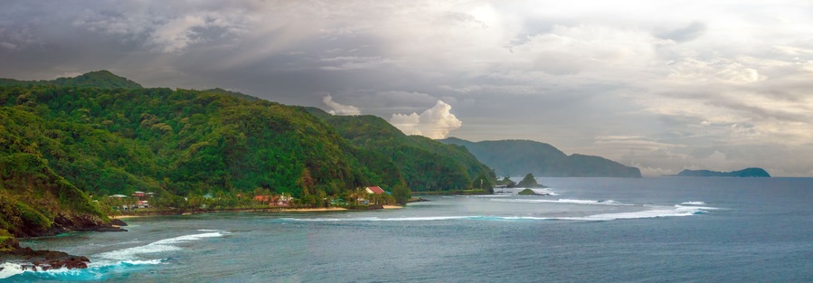 Scenic view of the coastline of Tutuila island, north of Pago Pago harbor, American Samoa, South Pacific, The famous camel rock can be seen in the distance