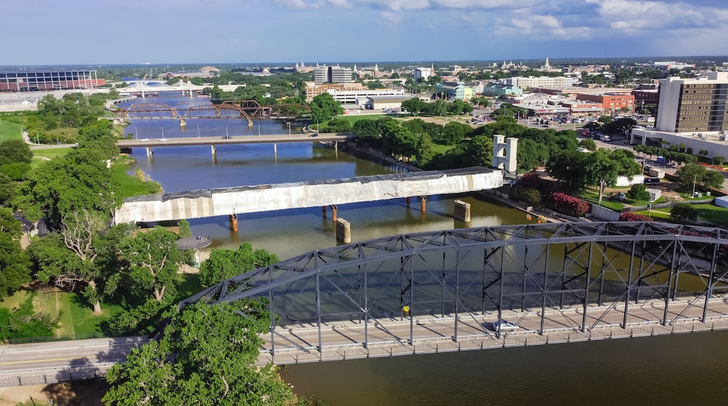 Top view four bridges including vehicular, Railway and Suspension Bridge cross the Brazos River in downtown Waco, Texas