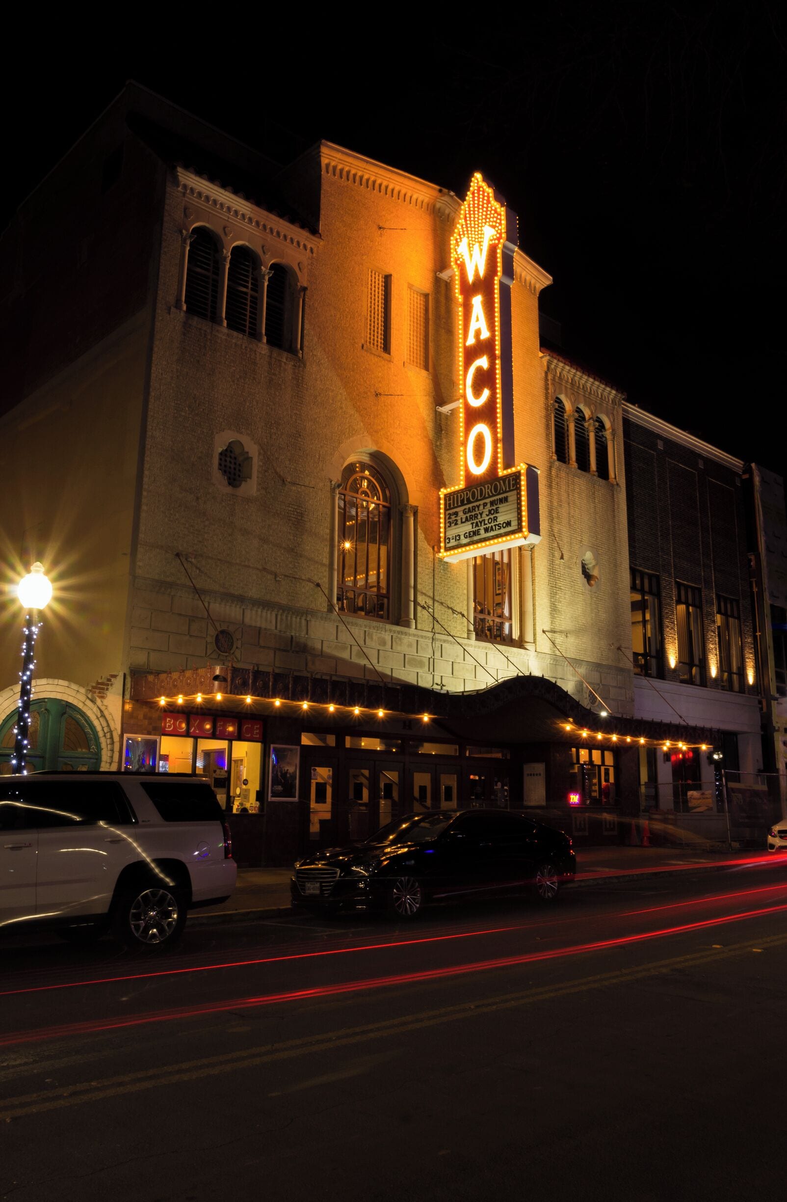 A theater with a marquee reading "WACO" and a sign for "Hippodrome."