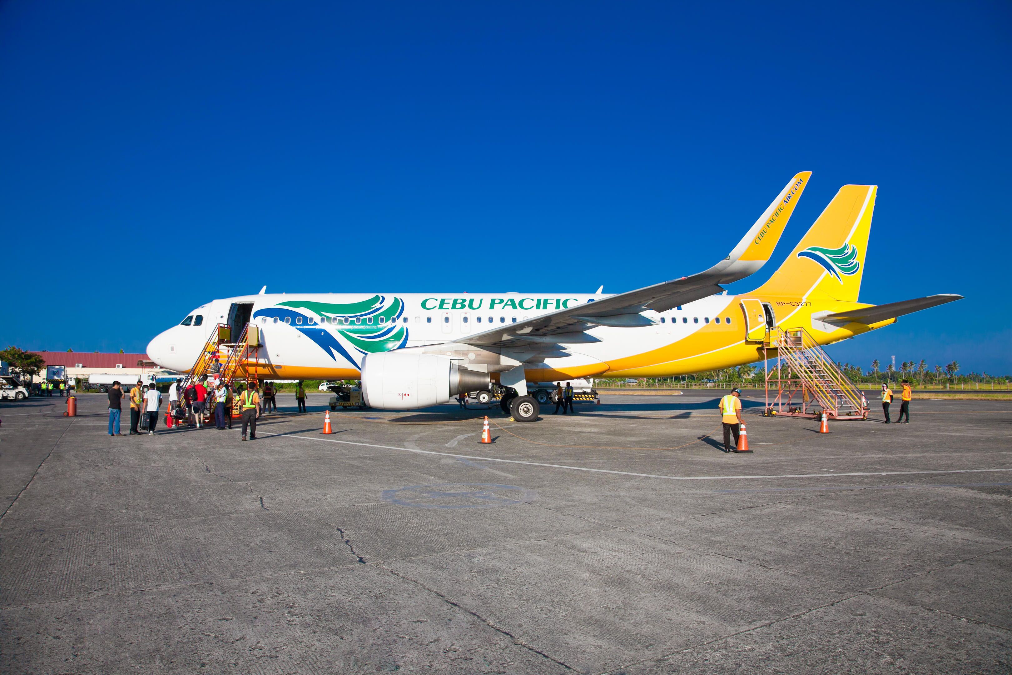 PD178C PUERTO PRINCESA PHILIPPINES - MARCH 23. 2016: Tourists embark on the Cebu Pacific aircraft  at Puerto Princesa International Airport on March 23, 2016