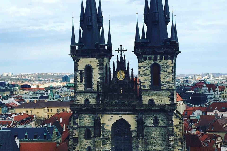 A historic church with two tall spires and a clock tower.