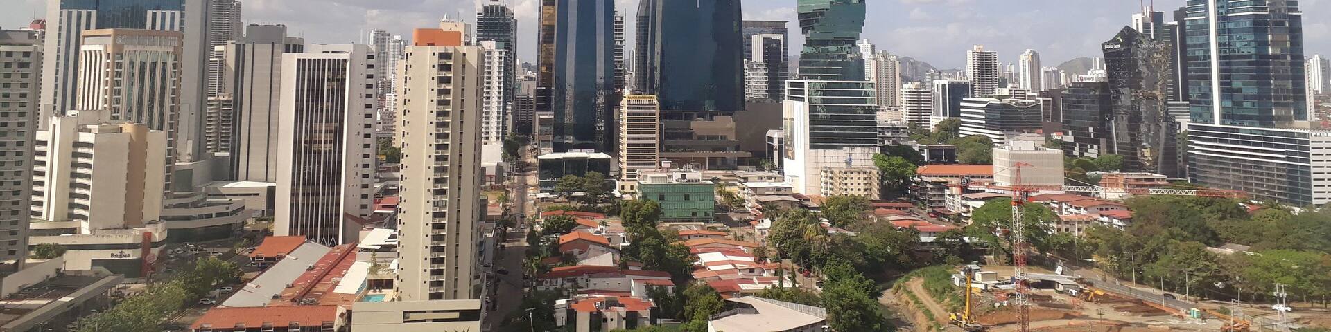 A cityscape with modern skyscrapers, including a distinctive twisting tower.