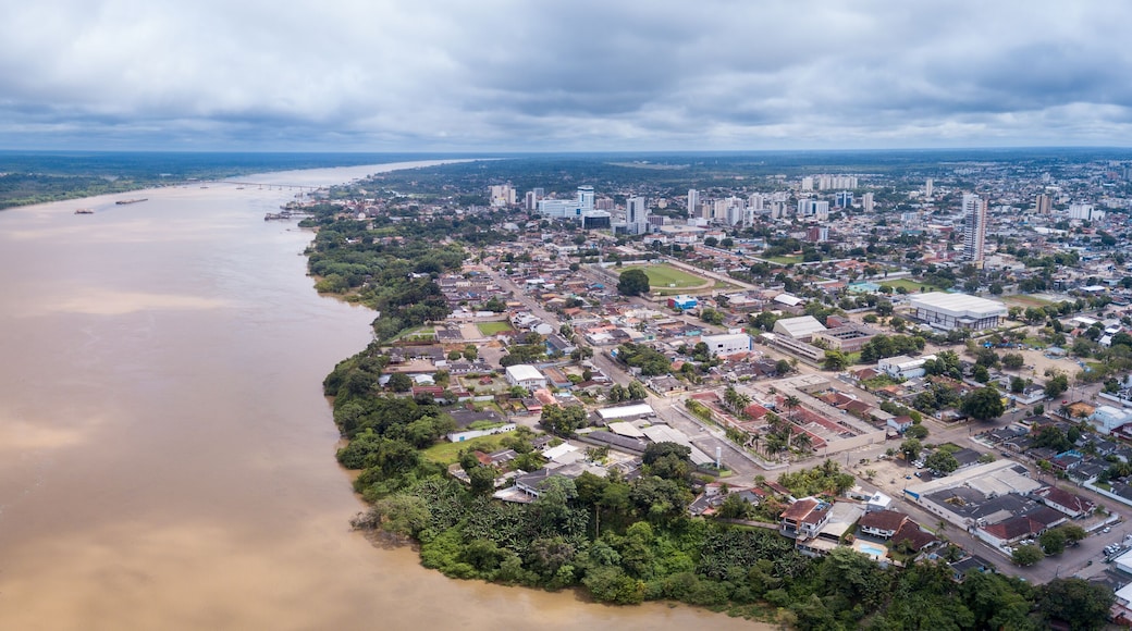 Aerial drone view of Porto Velho city center skyline, streets, squares and Madeira river. Amazon rainforest in the background on cloudy summer day. Rondonia state, Brazil.