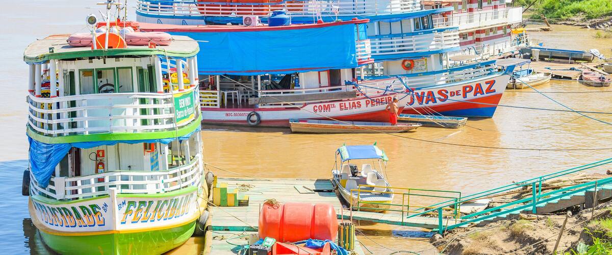 PORTO VELHO, BRAZIL - JUNE 16, 2017: Tour boats on the banks of the Madeira River. Boats departs from Estrada de Ferro Madeira-Mamore carrying many tourists with some onboard food services.