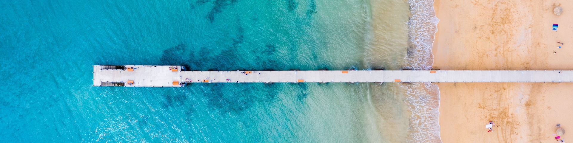 Aerial top view of Porto Santo island old pier, Porto Santo, Madeira, Portugal