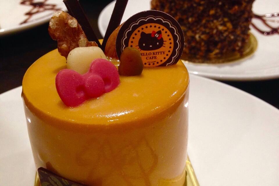 A cake with a Hello Kitty decoration on top.