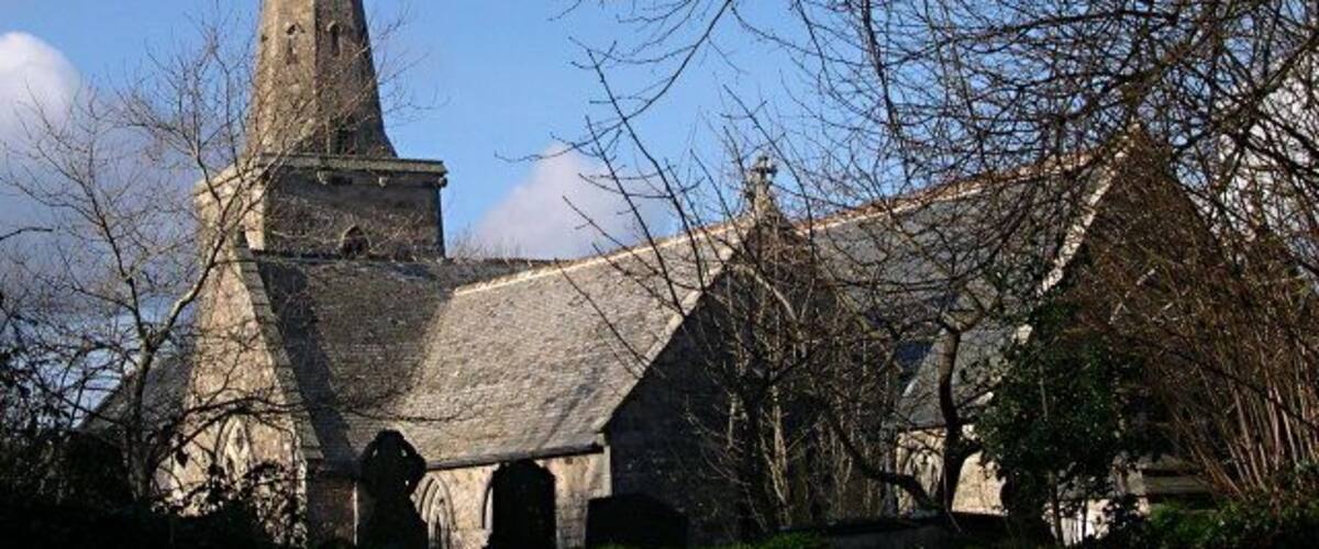 A historic church with a tall steeple and a pointed roof.