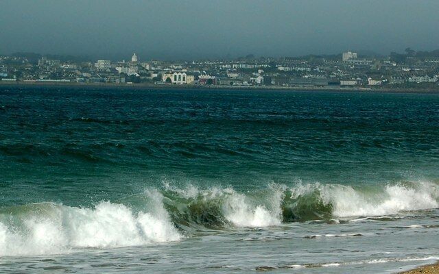 Choppy seas at Penzance Penzance can be seen basking in the morning sun in this view across Mount's Bay from Long Rock. Although it was sunny it was still a bit chilly on this side of Mount's Bay, and quite windy, as can be seen by the waves crashing on the shore.