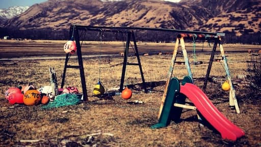 A child's play set with fishing buoys at Kalsin Beach