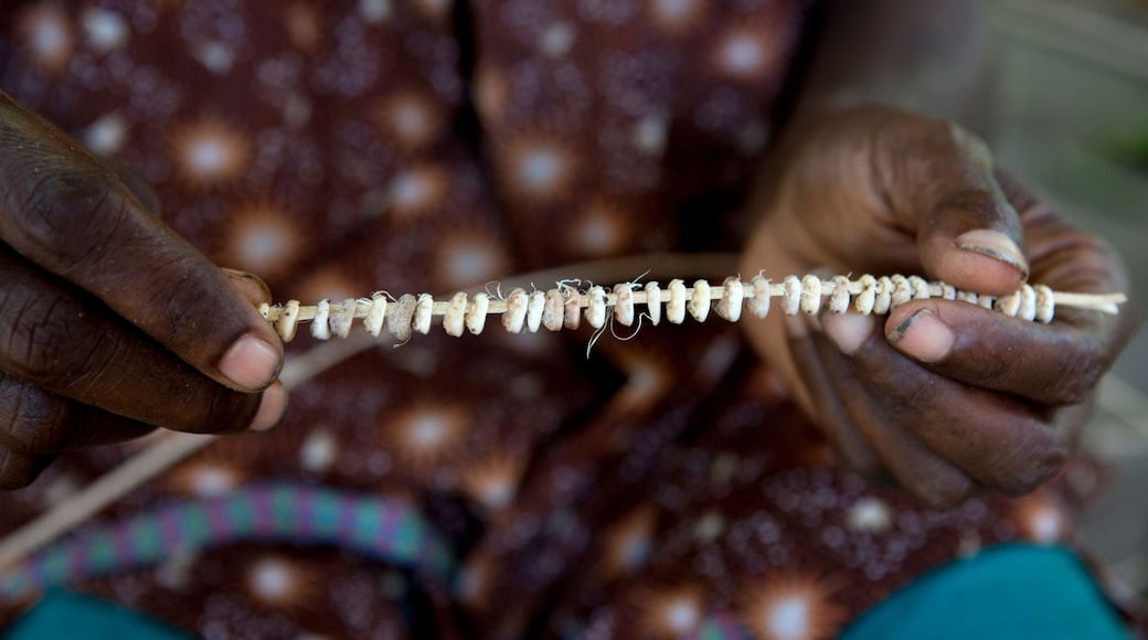 A person holding a string of beads.