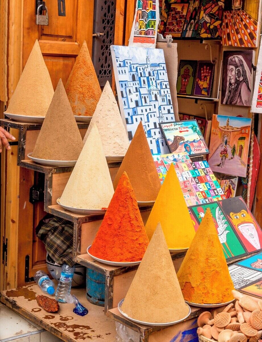 A display of colorful sand cones in a market setting.