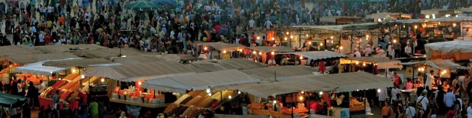 Jemaa el-Fnaa square_
Marrakech is a major city in the northwest African nation of Morocco. It is the fourth largest city in the country after Casablanca, Rabat and Fes, and is the capital of the mid-southwestern region of Marrakesh-Tensift-El Haouz. Marrakesh is possibly the most important of Morocco's four former imperial cities (cities that were built by Moroccan Berber empires). The red walls of the city have given the city the nickname of the "Red City". Marrakesh grew rapidly and established itself as a cultural, religious, and trading centre for the Maghreb and sub-Saharan Africa; Jemaa el-Fnaa is the busiest square in Africa.