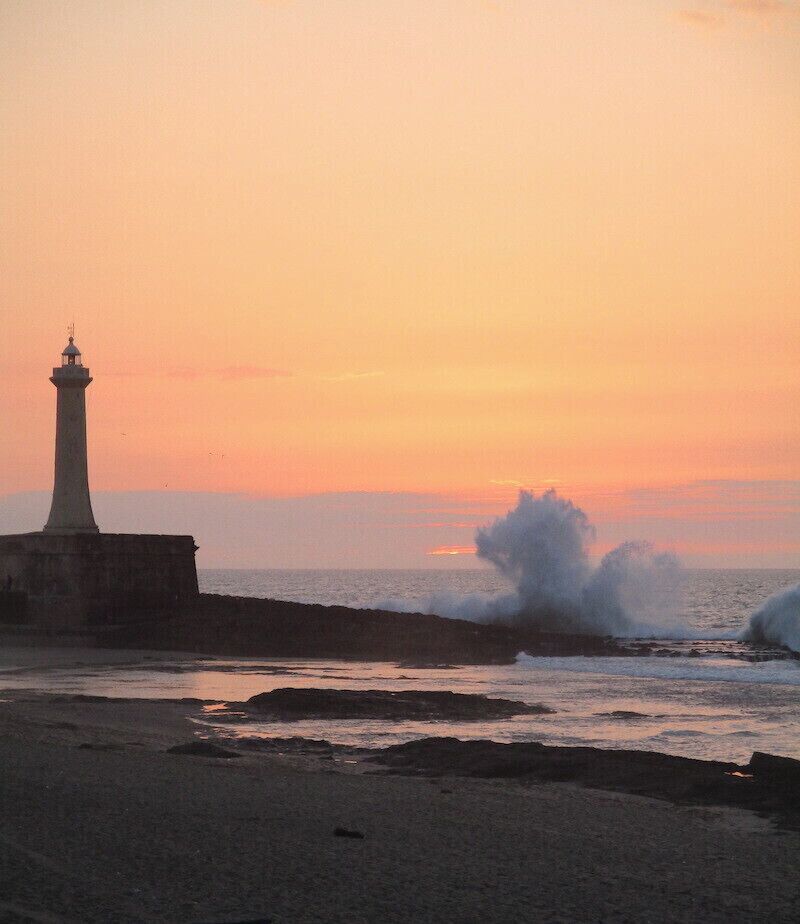 The surf crashing into the breakwater at the foot of a lighthouse, on the coast of Rabat.

No filters, this is the actual color of the sky.

#nature
https://davenotravels.blog