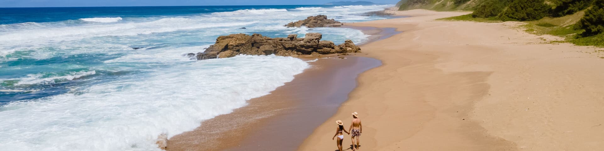 St Lucia South Africa, Rocks sand ocean, and blue coastal skyline at Mission Rocks beach near Cape Vidal in Isimangaliso Wetland Park in Zululand. South Africa St Lucia