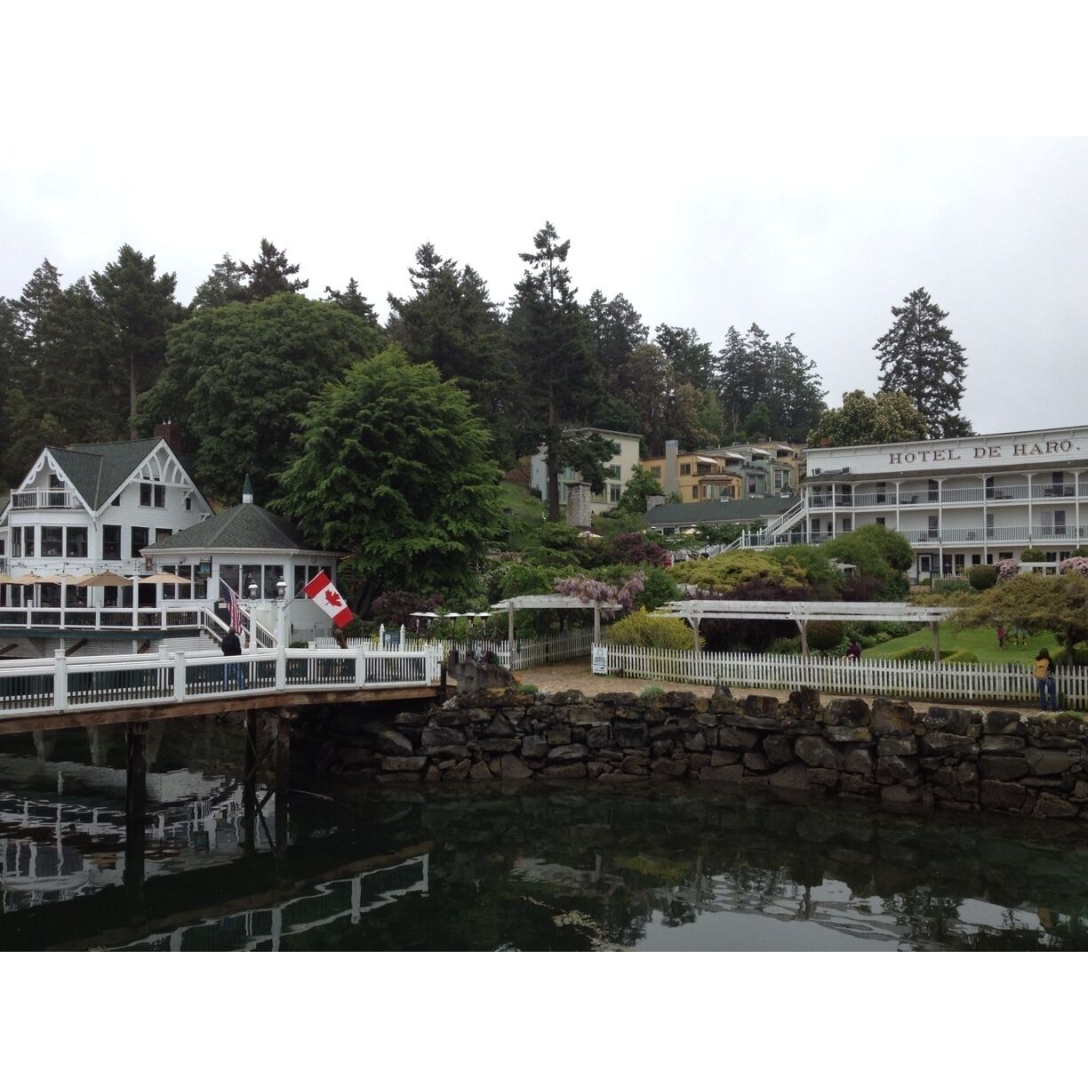 A waterfront area with a bridge, a dock, and a building labeled "HOTEL DE HARO."