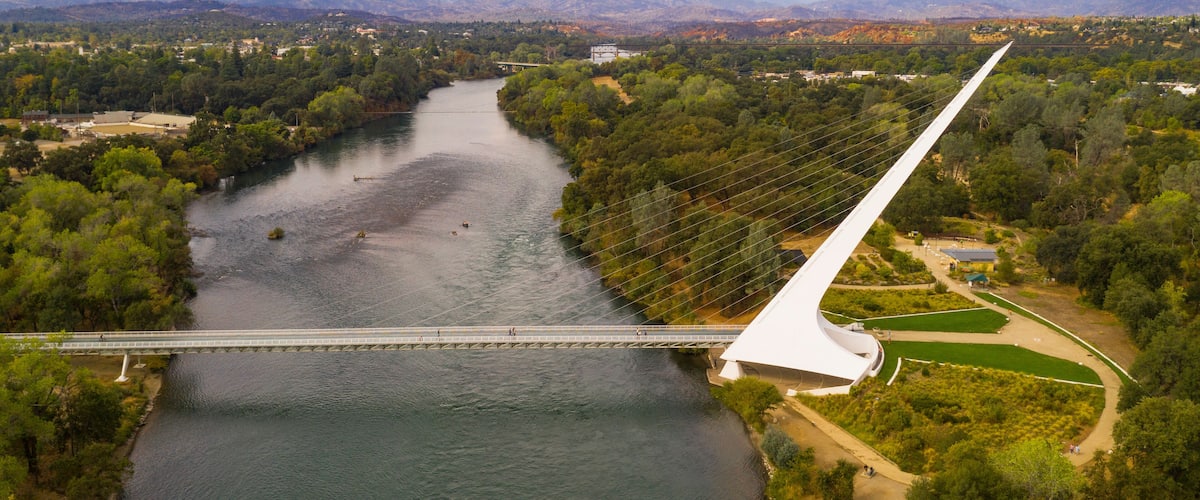 A river with a bridge and a white structure.