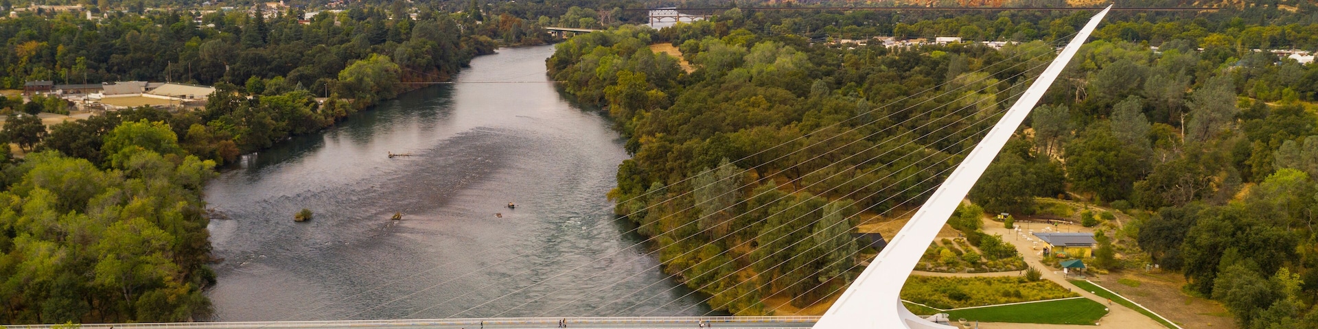 A river with a bridge and a white structure.