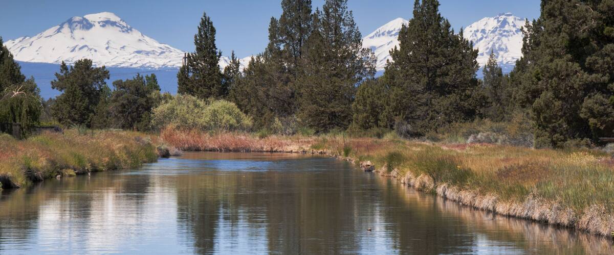 Three Sisters Mountain. View from Redmond, Oregon. River in foreground leading to mountains in the distant.; Shutterstock ID 197274512; Purchase Order: -