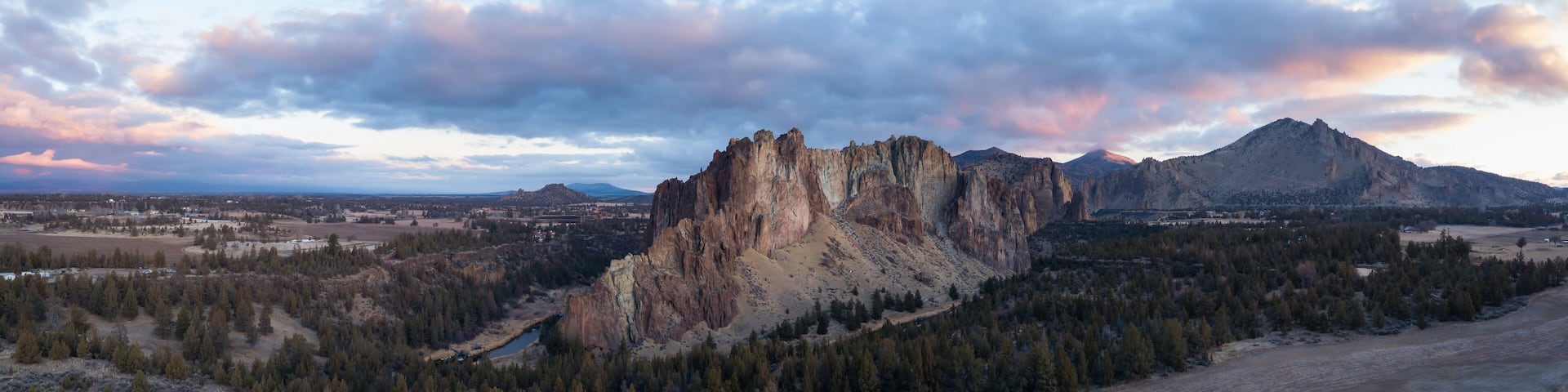 Aerial panoramic view of a beautiful landmark, Smith Rock, famous for rockclimbing. Taken in Redmond, Oregon, America, during a vibrant sunrise.