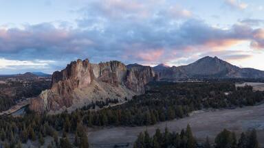 Aerial panoramic view of a beautiful landmark, Smith Rock, famous for rockclimbing. Taken in Redmond, Oregon, America, during a vibrant sunrise.