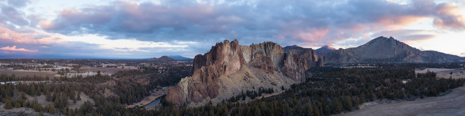 Aerial panoramic view of a beautiful landmark, Smith Rock, famous for rockclimbing. Taken in Redmond, Oregon, America, during a vibrant sunrise.
