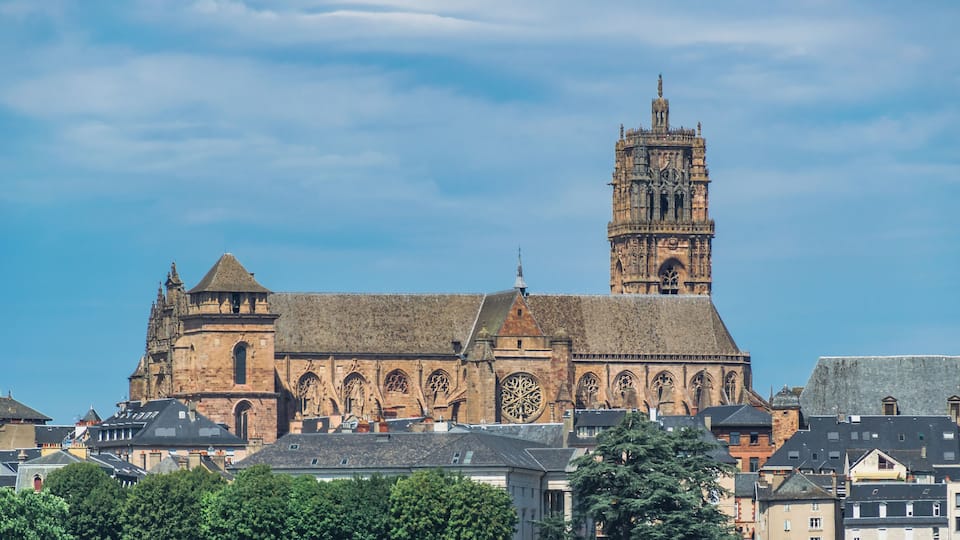 A historic cathedral with a prominent clock tower and intricate architectural details.