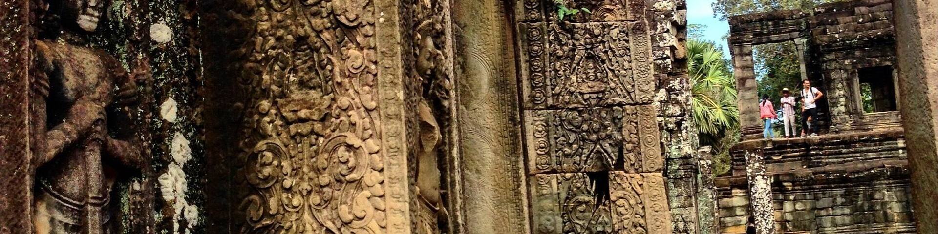 An ancient stone structure with intricate carvings and a large doorway.