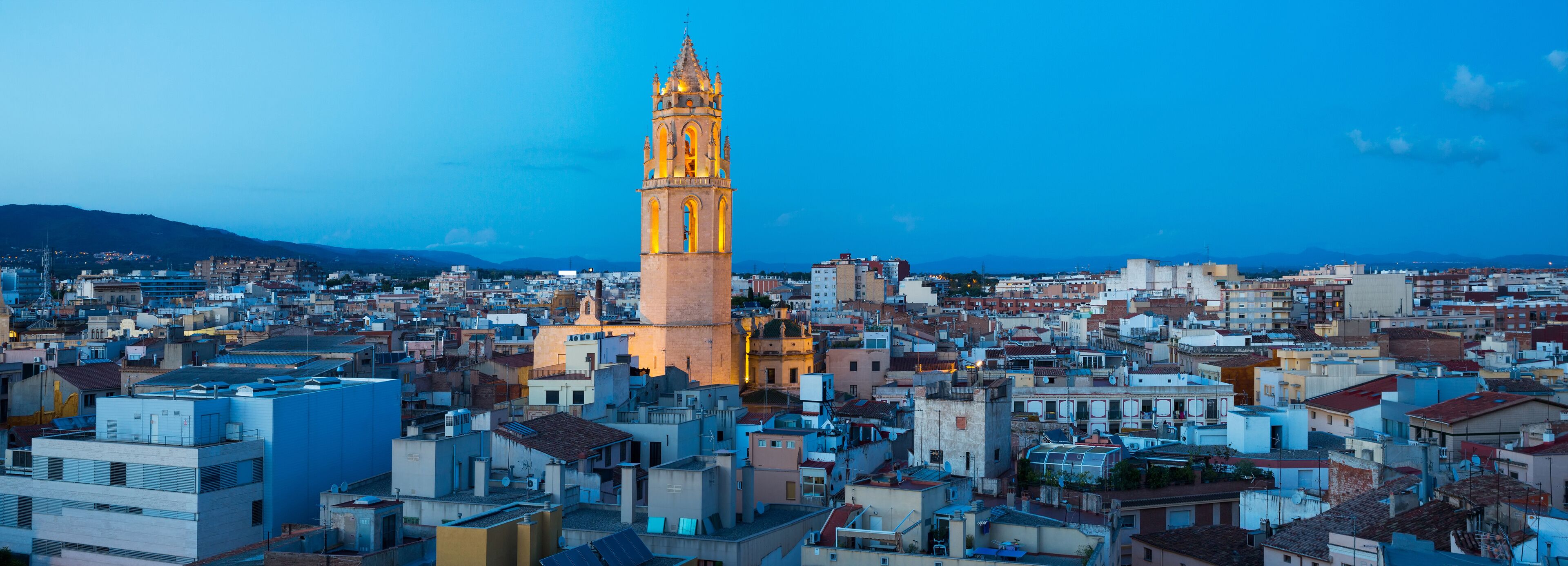 A cityscape with a prominent tower and densely packed buildings.