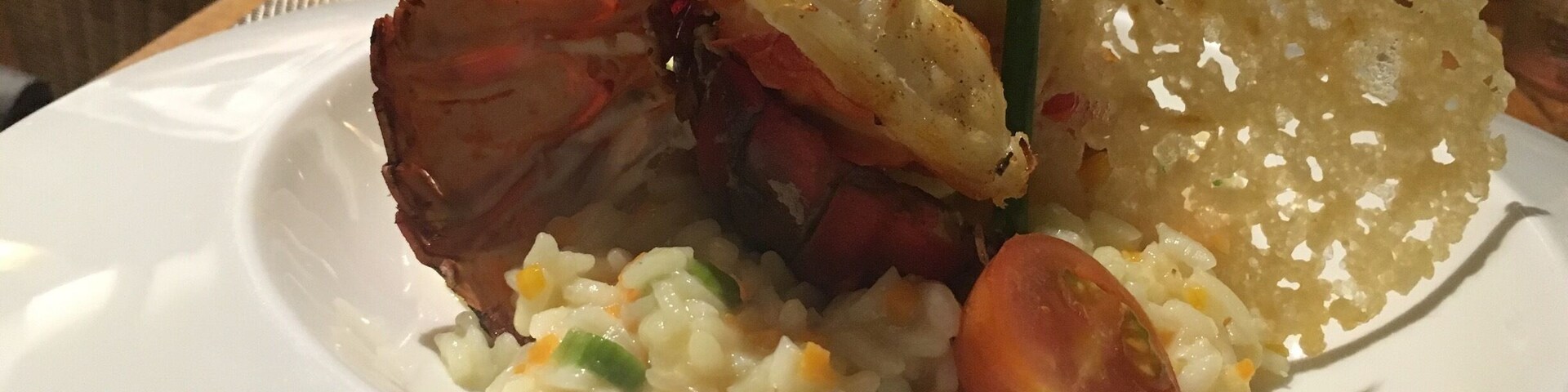 Un plato de comida con arroz, verduras y un trozo de carne.