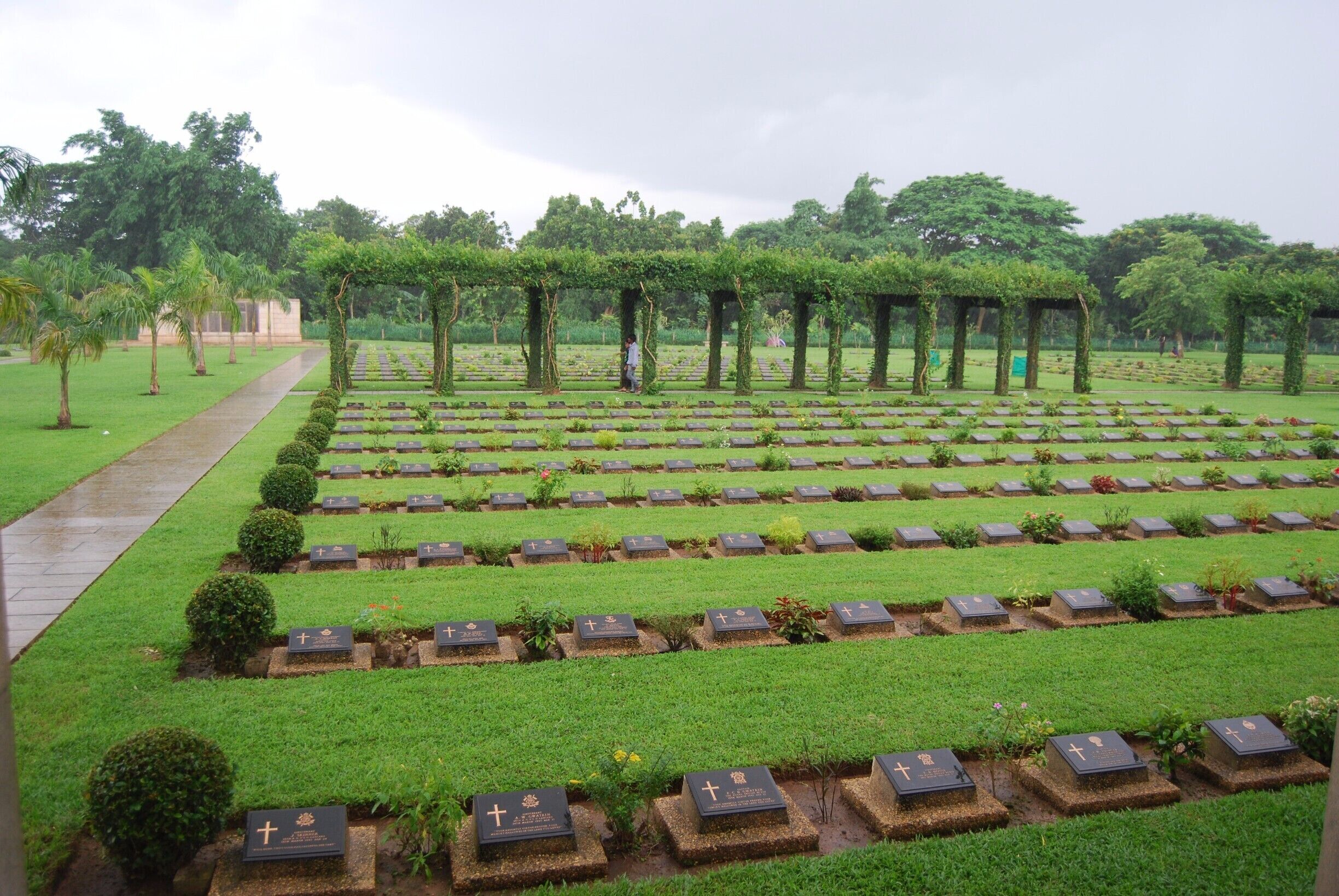 This place is known by locals as the war cemetery or the Allied cemetery. It is an incredibly well maintained cemetery honoring the soldiers who lost their lives in WWI and WWII. We were overwhelmed by the number of graves and the 27,000 other soldiers who were honored but unable to be buried. If you are in Yangon you should definitely make the trip to the cemetery. 

To get here we took the circle train out of Yangon Central Railway station to the stop Kyaikkale (one after the Golf Course stop). From that station we walked to the road and hailed a taxi. It took 4 or 5 to find someone who could speak enough English to take us there. We paid 8000 Kyat (appr. 8 USD) for the ride there, for him to wait, and for the ride back to the station. It takes about 15-20 minutes in the taxi to get there. The locals use the cemetery more like a park and were more interested in us than anything else. This was irritating but as tourism is so little still it is understandable. Entrance is free.