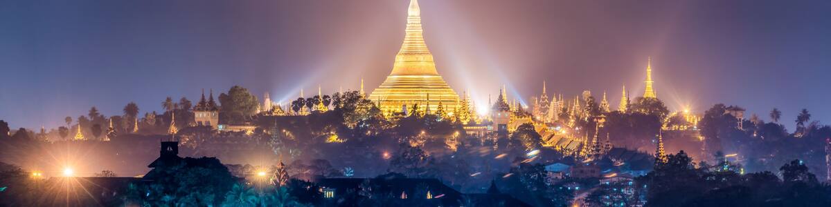 Panoramic view of the golden Shwedagon Pagoda at night, Yangon, Myanmar