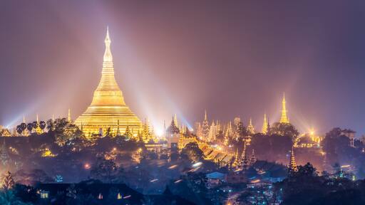 Panoramic view of the golden Shwedagon Pagoda at night, Yangon, Myanmar